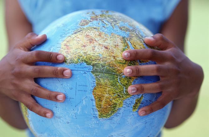 Girl's hands holding globe
